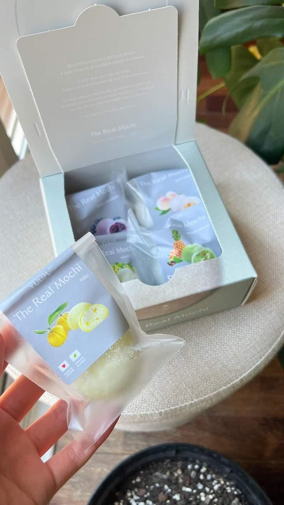 Box of frozen Japanese mochi with Yuzu in hand